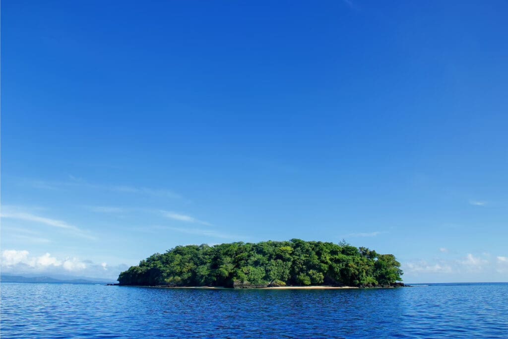 Hidden Places Around the World,

Taveuni Island surrounded by calm blue waters under a clear blue sky.